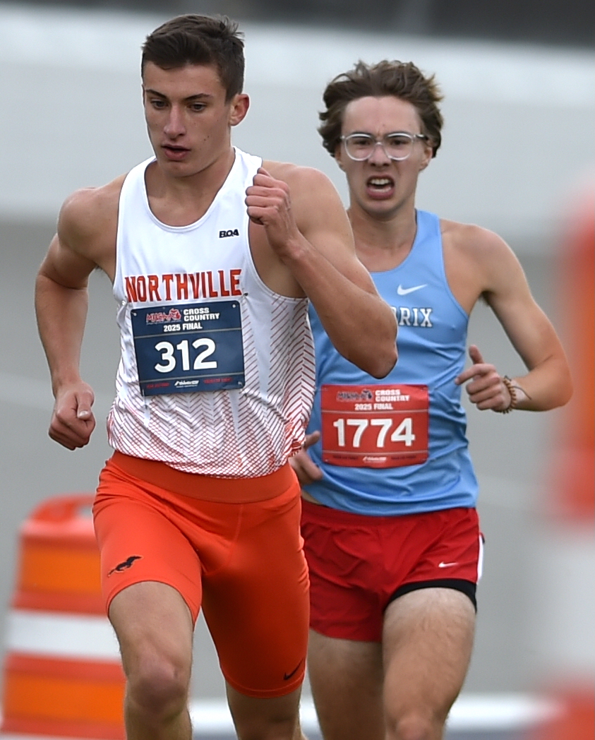 Northville’s Ben Hartigan (312) stays a pace ahead of Kalamazoo Loy Norrix’s Jackson Lam.