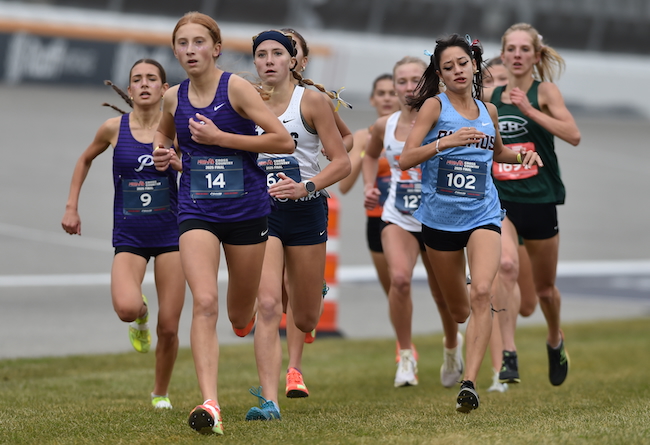 The Pioneers’ Hana Boggess (9) and Keira Von Blon (14) run with a one of the fastest packs during the Division 1 race.