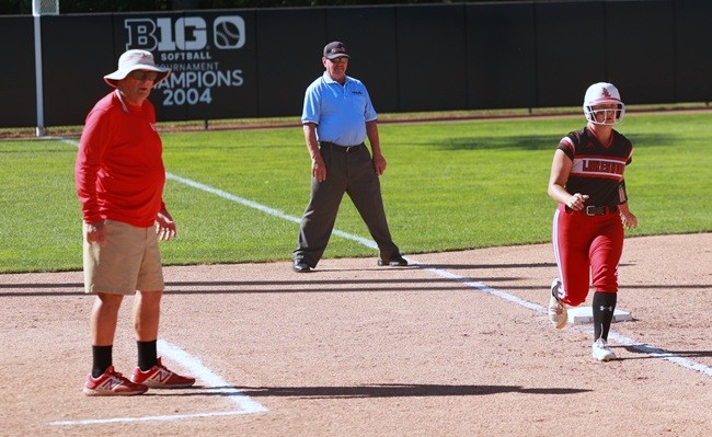 Denny Dock, far left, coaches a base runner during Stevensville Lakeshore’s 2022 Semifinal win.