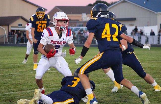 Owen Romancky (21) leaps to haul in a pass against Hillman.
