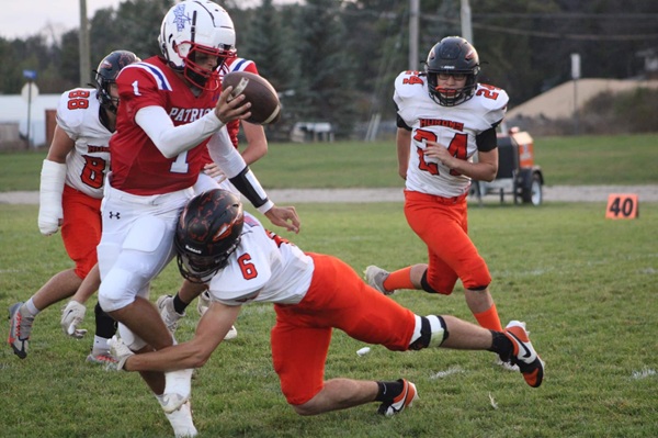 Patriots quarterback Dylan Chichowski works to elude a Rogers City defender.