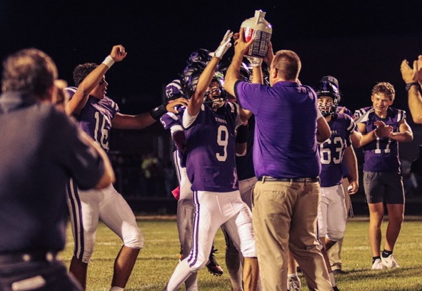 Garcia and coach Phil Fortier celebrate with the "Blood, Sweat & Tears" trophy after Shelby's win over Hart. 