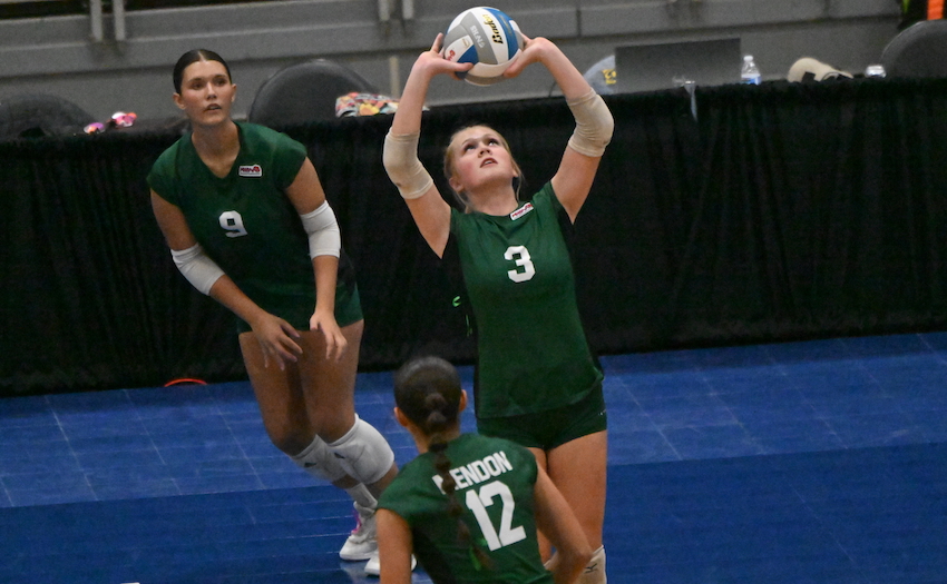 Mendon junior Karyssa Holtz (3) sets as teammates Cienna Nightingale (9) and Sabrina Monroy make their moves toward the net.