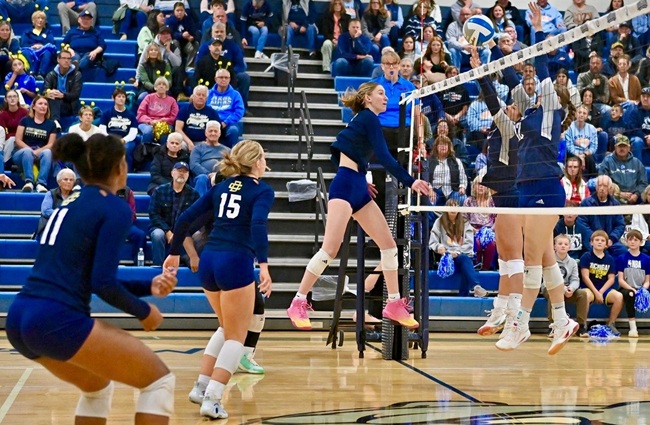 Country Day's Leah Green (14) sends a kill attempt toward a North Branch block during the Yellowjackets' Regional Final win. 