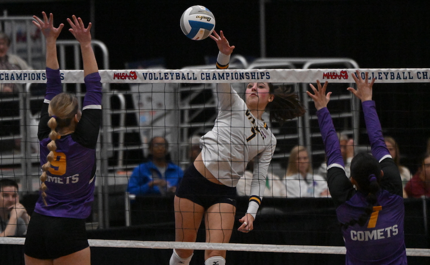 Valley Lutheran sophomore Grace Parker (7) attempts to split by a block by Keller and senior Lydia Boley. 