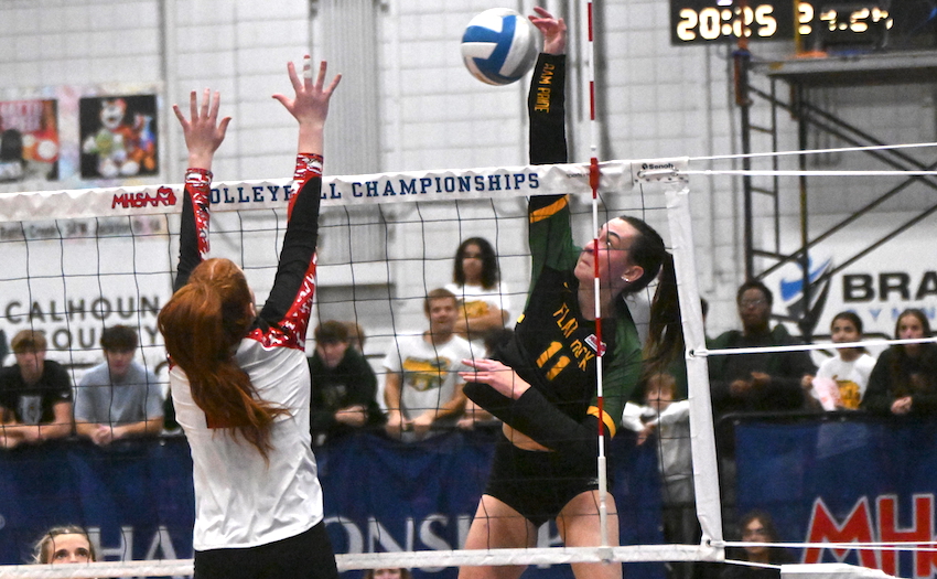 Flat Rock junior Sarah Giroux connects on a kill attempt. 