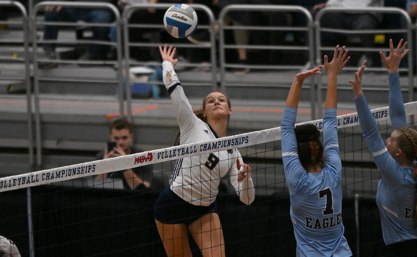 Detroit Country Day’s Elise Hiemstra (9) winds up for a hit during her team’s 18-25, 30-28, 25-23, 25-23 win over Grand Rapids Christian. 
