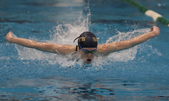 Caroline Bryan swims to first place in the 100 butterfly for Grosse Pointe South. 