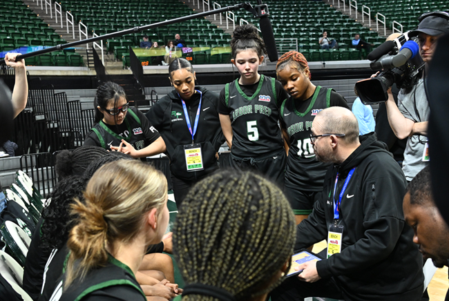 Stine talks things over with his Arbor Prep players during a break in the championship victory.