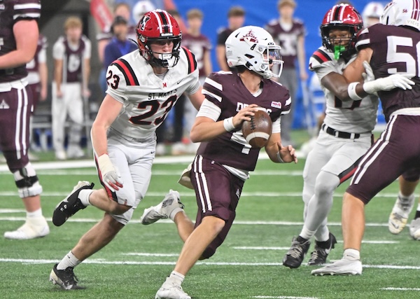 St. Mary’s Gage Nessen (23) pursues Dexter quarterback Cooper Arnedt.