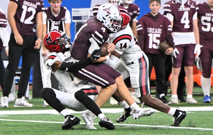 Orchard Lake St. Mary’s Kareem Pruit (7) brings down Dexter quarterback Cooper Arnedt in 11-player Division 2.