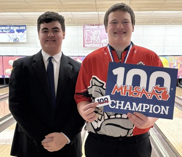 Butler, right, and “bodyguard” Xavier Hart take a photo after Butler won the Division 2 singles championship last season. 