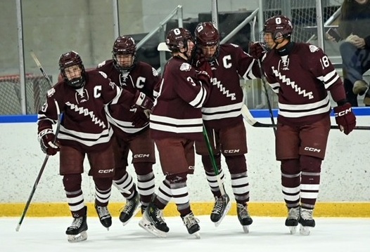 A group of Bulldogs skate side by side, including Vander Veen and Lewis Gardine (18). 