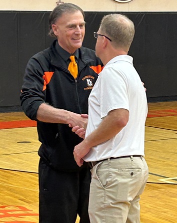 Scott Hancock shakes hands with a Kingsley assistant coach.