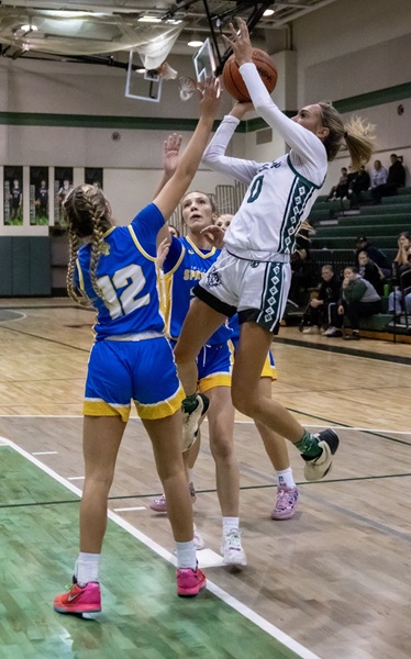 Zinn elevates for a shot while defended by a pair of Panthers. 