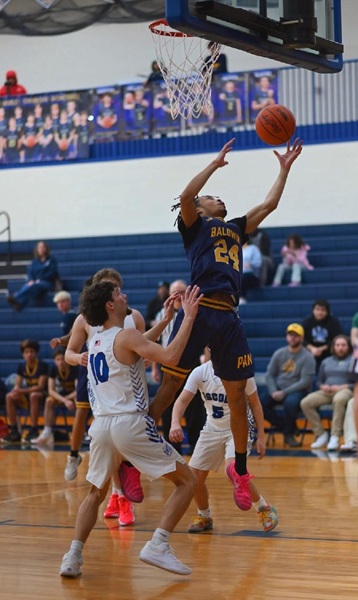 Pierre Johnson grabs a rebound against Oscoda during a 52-41 victory on Jan. 3.