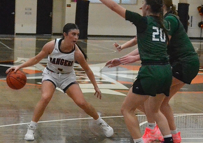Hiller handles the ball while defended by multiple Pine River players. 
