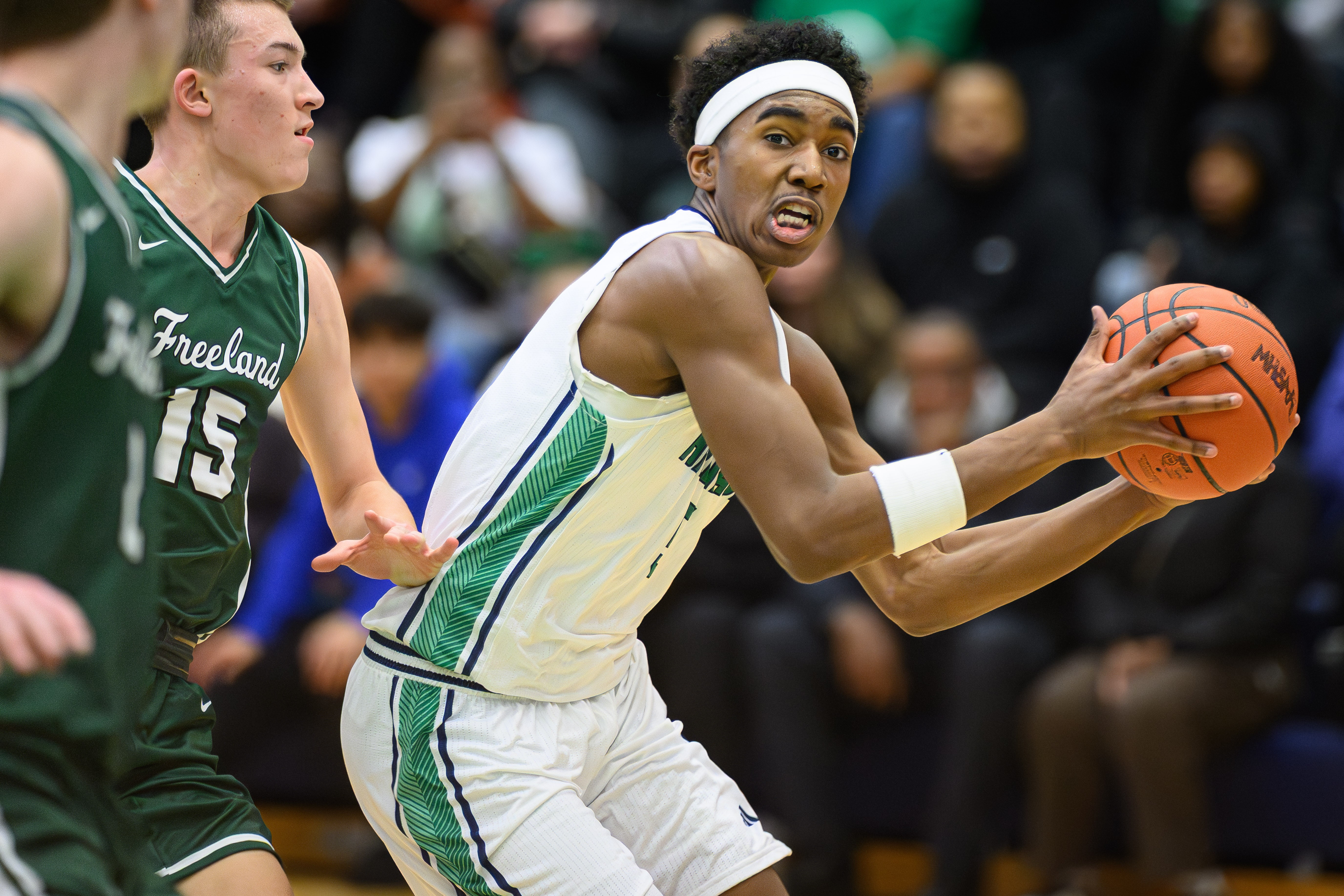 Saginaw Heritage senior Jaylin Cooper (5) drives past a Freeland defender during their Jan. 6 matchup, won by the Falcons 65-58.