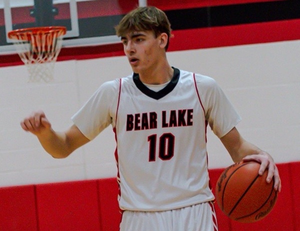 Grady Harless directs the offense against Mason County Eastern. (Below) Myles Harless elevates for a jumper against Leland.