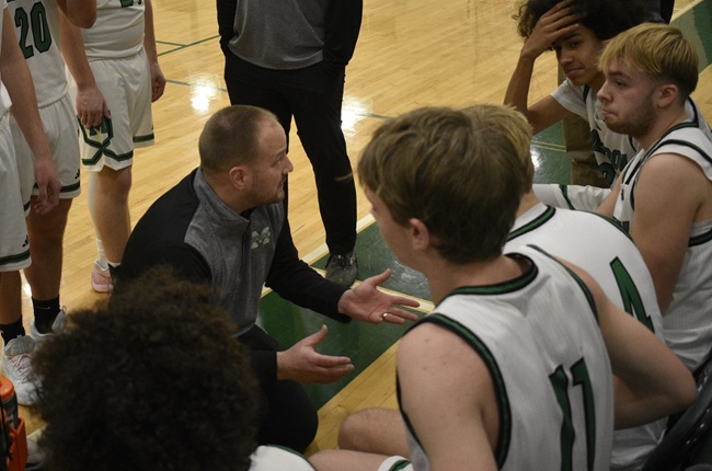 Second-year Mendon varsity boys basketball coach Matt Gorham addresses his team during a recent home game against Athens.