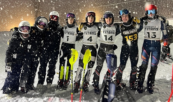 The Lewandowski quads stand for a photo with friends from Traverse City Central during Monday’s Regional. 