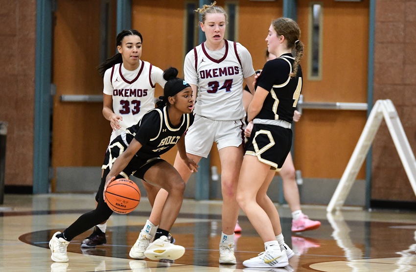Holt’s Olivia Gadson (11) follow’s a teammate’s screen during the Rams’ 51-42 win over Okemos on Feb. 10.