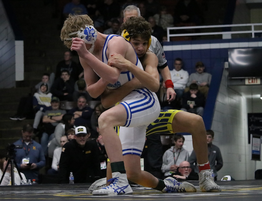 Hartland’s Jonah McPherson, right, wraps up opponent Brent Coak at 120 pounds. 