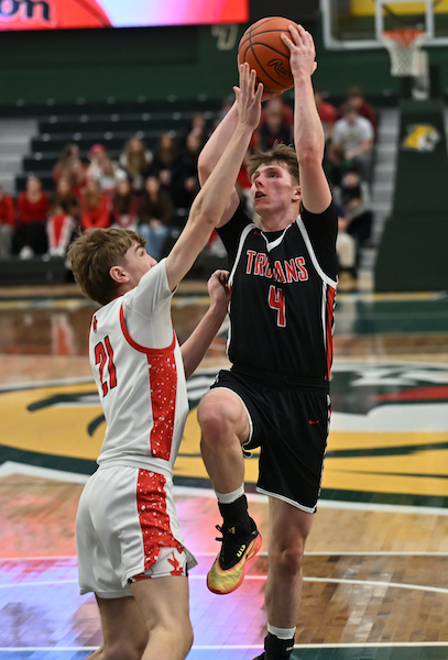 Forest Park's Dax Huuki goes up for two against Marquette's Carter Fierstine at the Vandament Arena. 