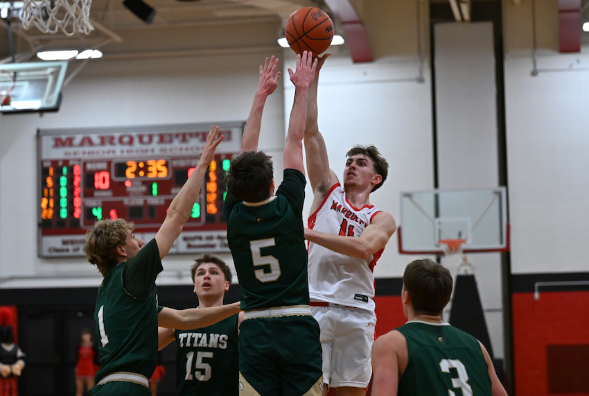 Marquette's Ford Richardson&nbsp;gets up&nbsp;a shot&nbsp;while&nbsp;surrounded by Traverse City West's Ashton Royle (15), Jacob Banish (1), Blake LaFaive (5), and Carter Grubb (3)&nbsp;during the Sentinels’&nbsp;69-52 Division 1 District Final win. 