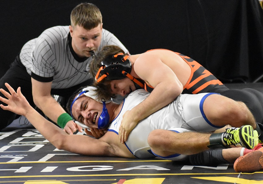 Hudson's Nicholas Sorrow, right, works toward a pin at 126 pounds against Lawton's Austin Garcia.