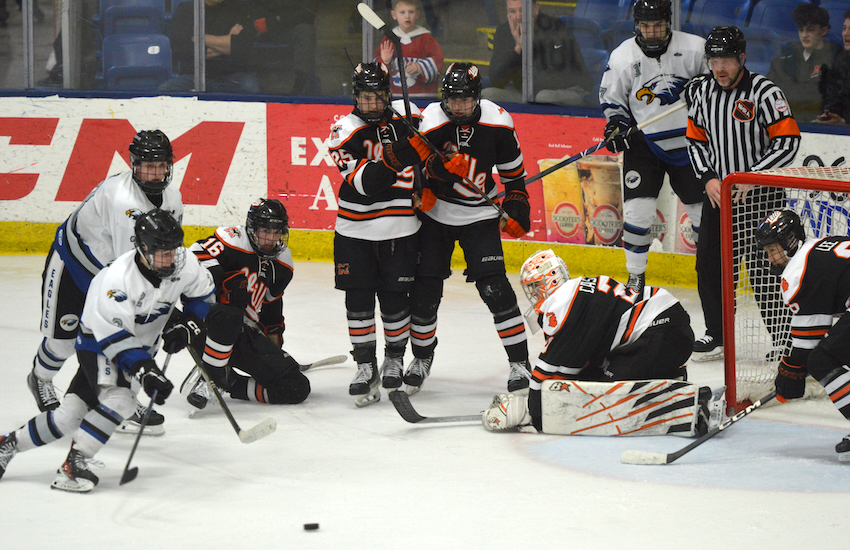 Eisenhower (24-7) closes in on a loose puck in front of Northville's net.&nbsp;