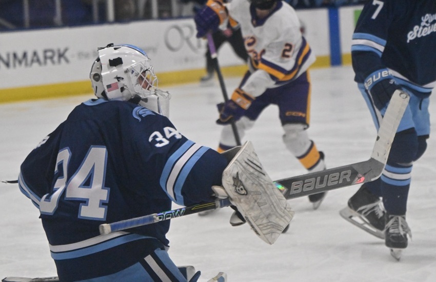 Spartans goalie Drew Allen (34) turns away a Caledonia shot to preserve the 1-1 score during the opening period. He made 24 saves.&nbsp;