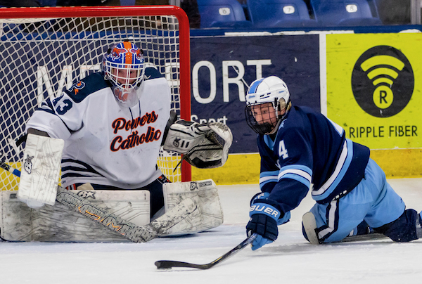 Stevenson’s Tyler Breitbach (4) gets a stick on the puck in front of the Powers net and goalie Hunter Clark.