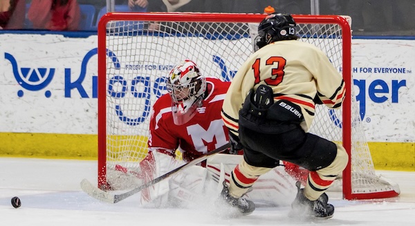 The Gremlins’ Noah Maillette (13) moves toward a loose puck in front of the St. Mary’s net and goalie Thomas Reeber. 