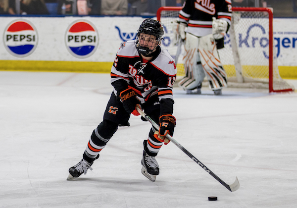 Northville’s Jake Jurcisin (12) controls the puck on his team’s end of the ice. 