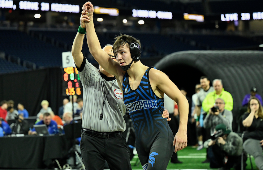 Wyatt Burns' arms is raised in victory after his title triumph. 