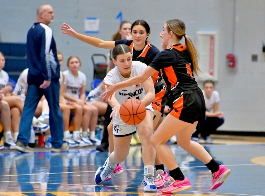 A pair of Almont defenders block the passing lanes against North Branch during the Broncos' 47-44 Division 2 District win.