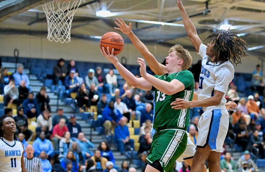 Freeland’s Tristan Comer (13) scoops a shot during the Falcons’ Regional Final win over Flint Hamady.