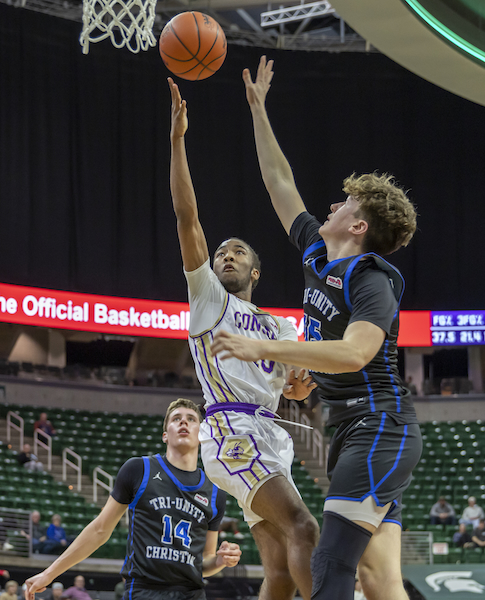 Darrell Dean Jr. (10) drives to the basket with Tri-unity’s Andrew Hofmann (24) defending. 