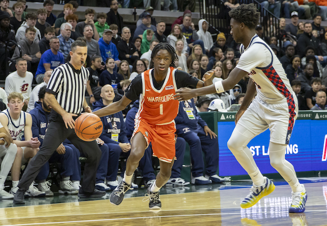 Brother Rice’s Jordan McDaniel (1) makes his move to the basket. 
