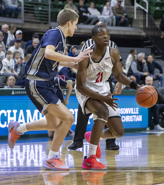 Maurice Jackson (21) considers his options from just outside the arc. 