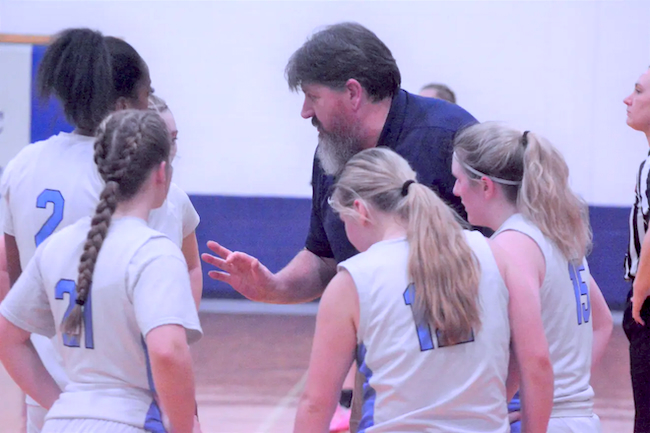 Comets coach Jake Huffman talks things over with his team.