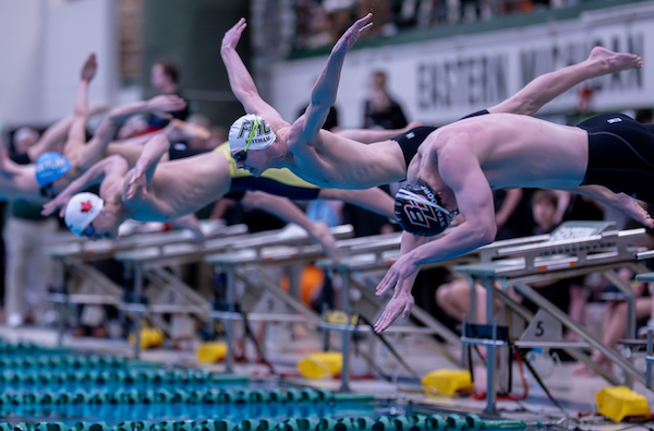 Forest Hills Central's Lucas Witham launches at the start of the 100 freestyle. 