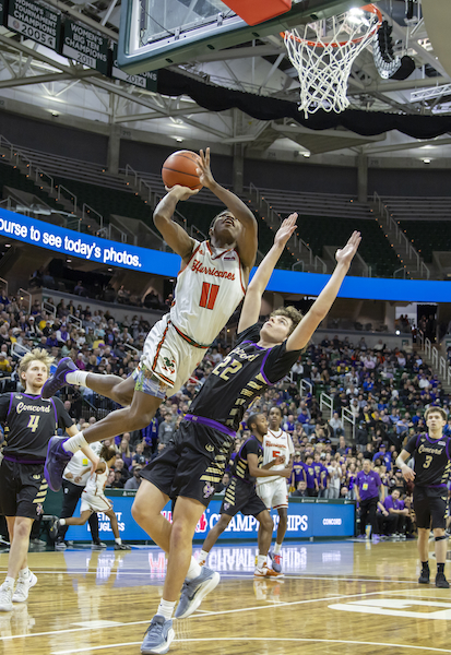 Douglass’ Jacodi Nathan (11) drives hard to the hoop with Concord’s Tyler Rundle working to wall him off.