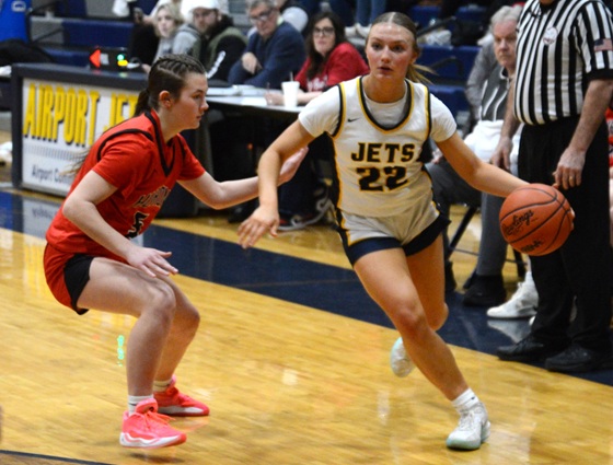 Sophia Mator (22) drives toward the lane against New Boston Huron.
