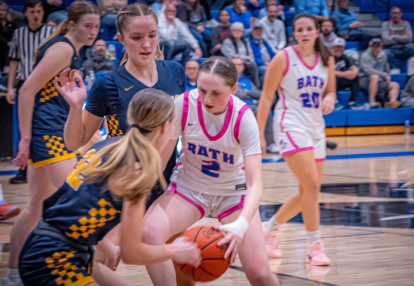 A pair of Pewamo-Westphalia defenders, including Adrianna Eklund, close in on a Bath ball handler during a regular-season win.