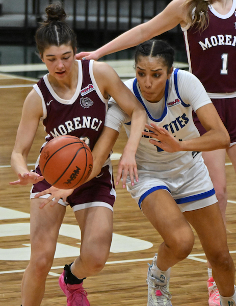 Morenci’s Emersyn Bachelder (33) and Ishpeming’s Mya Hemmer (14) contend for a loose ball. 