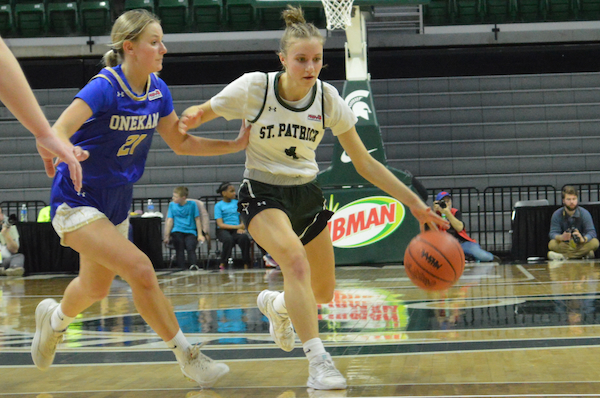 The Shamrocks’ Lily Sandborn (4) makes her move into the lane with Addy Zeller defending.