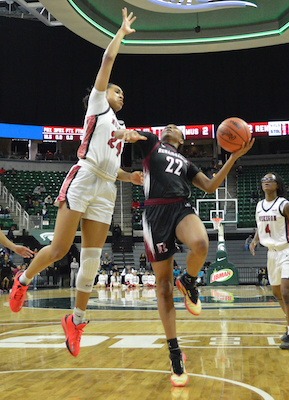 Jaebri’an Autry (22) works to get a shot up over the Big Reds’ Dy’nasti Bell (24). 