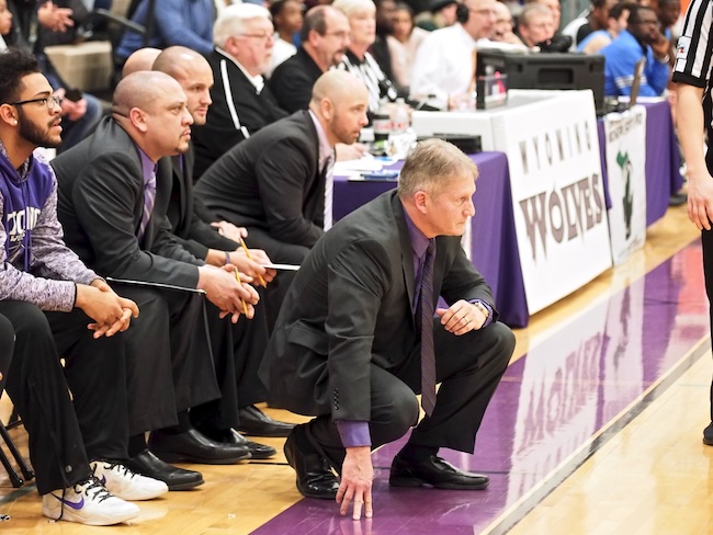 Vander Klay (kneeling) coaches his Wyoming High team. 